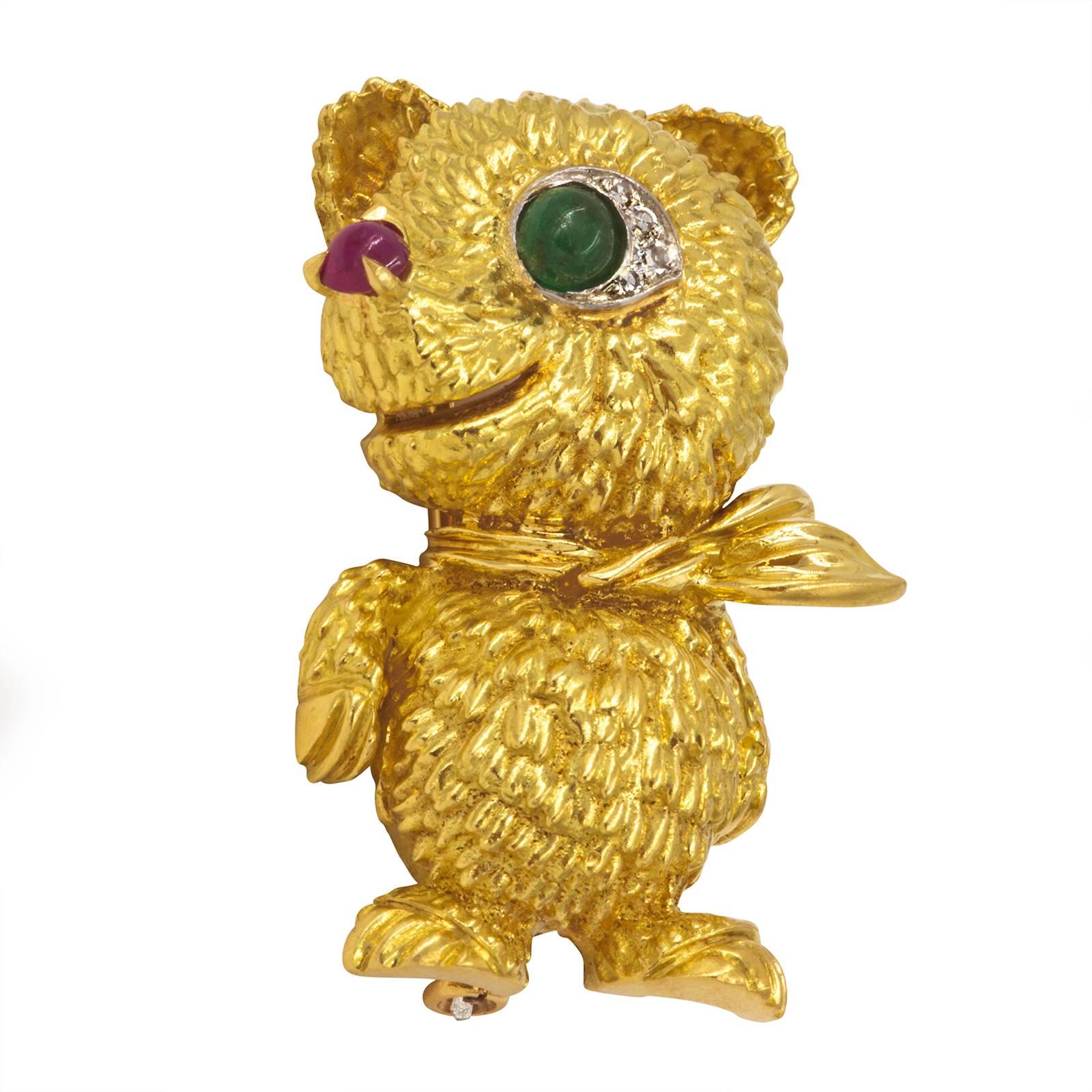 Sassy  bear dressed with a tie.  750, 18k yellow gold, from 1950s.
Cabochon emerald eye with diamond lashes.  Bright cabochon red ruby nose.
Hallmarks on backside 