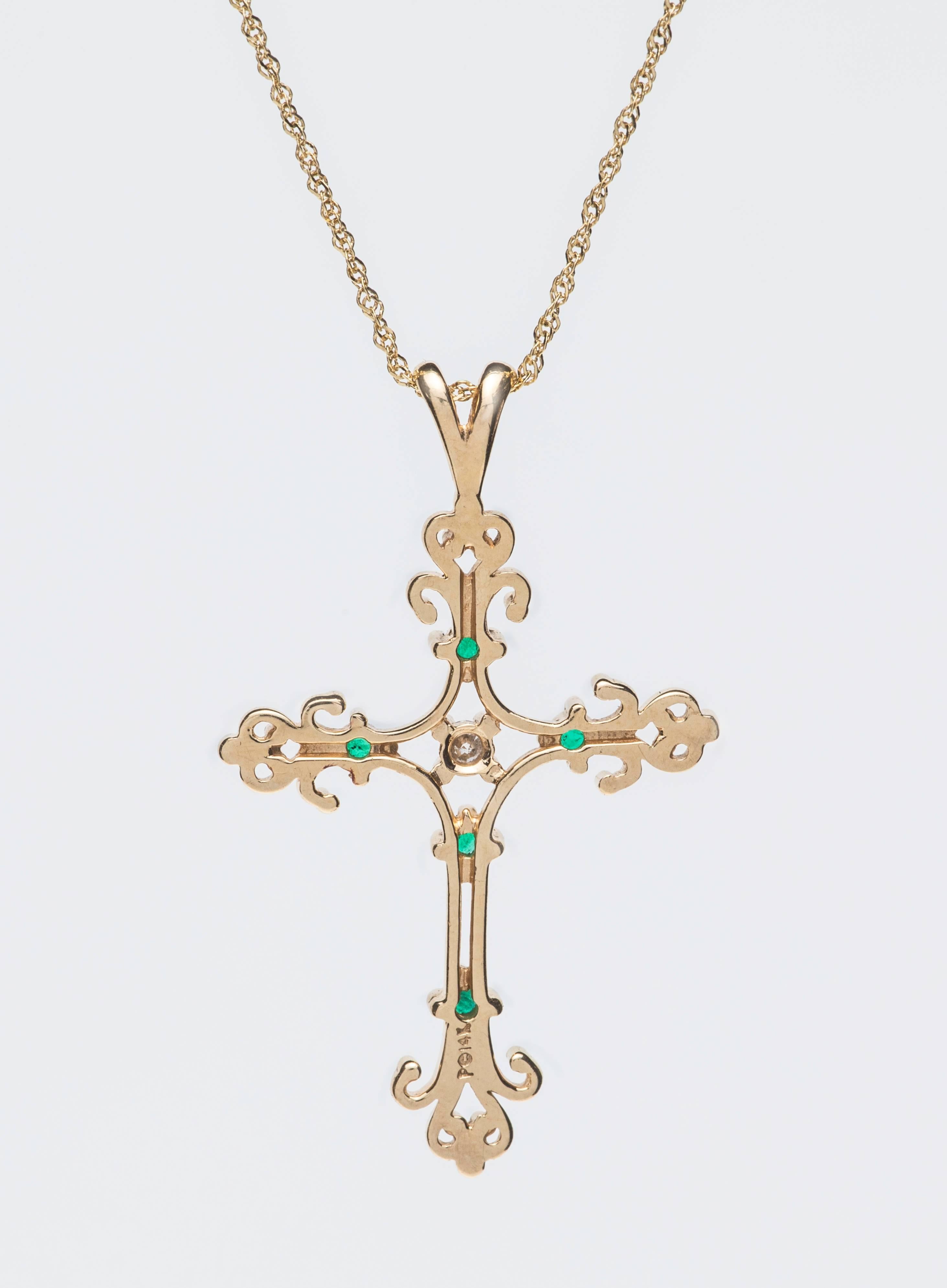 Beautiful and delicate filigree cross.  14k yellow gold with 17.5" 14k gold chain.
Five emerald stones with center diamond.  