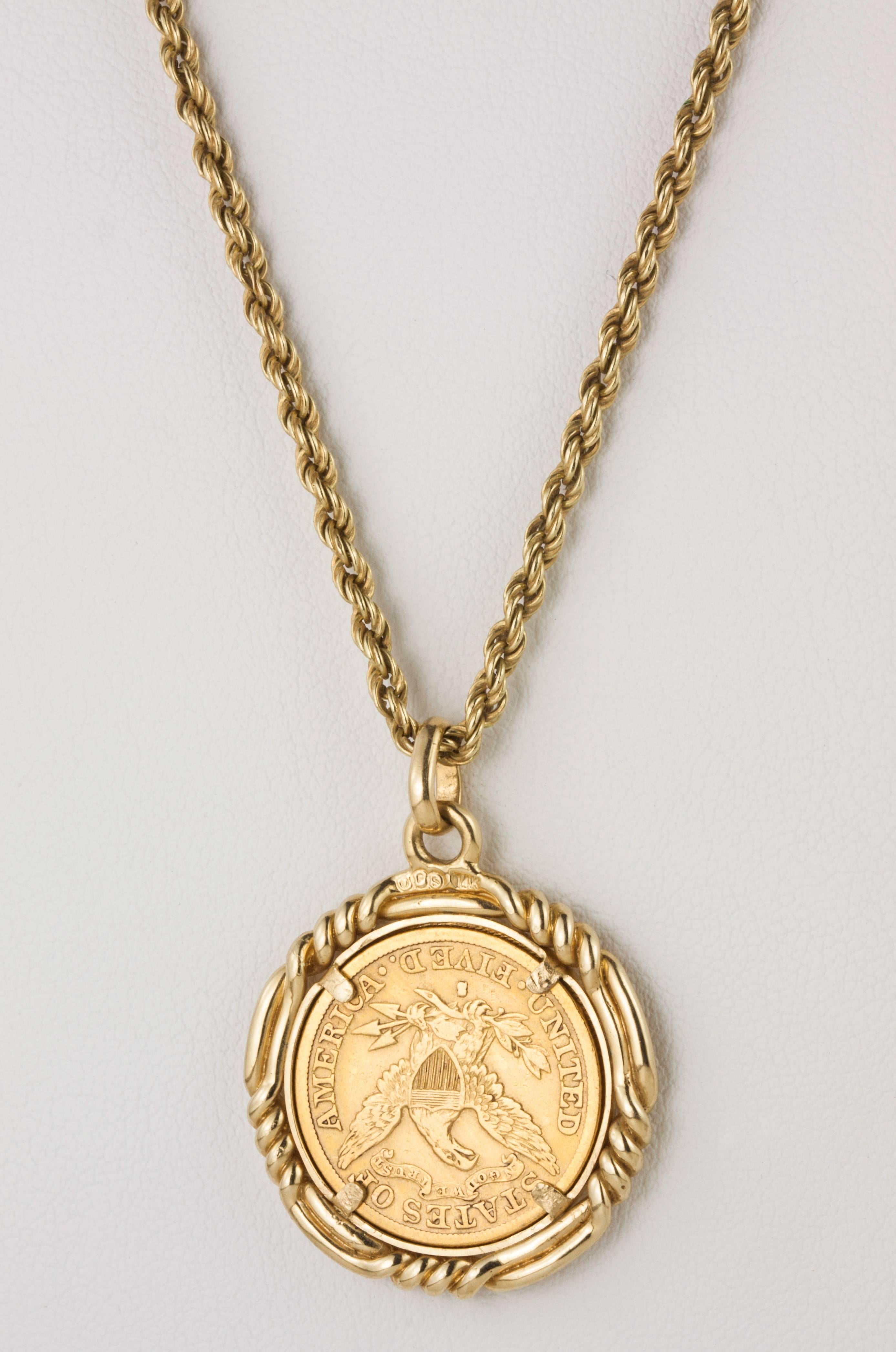   C. 1892 United States 22k US $5 gold coin  1/4 oz.  Cased  in 14k gold frame.  Hangs from   19