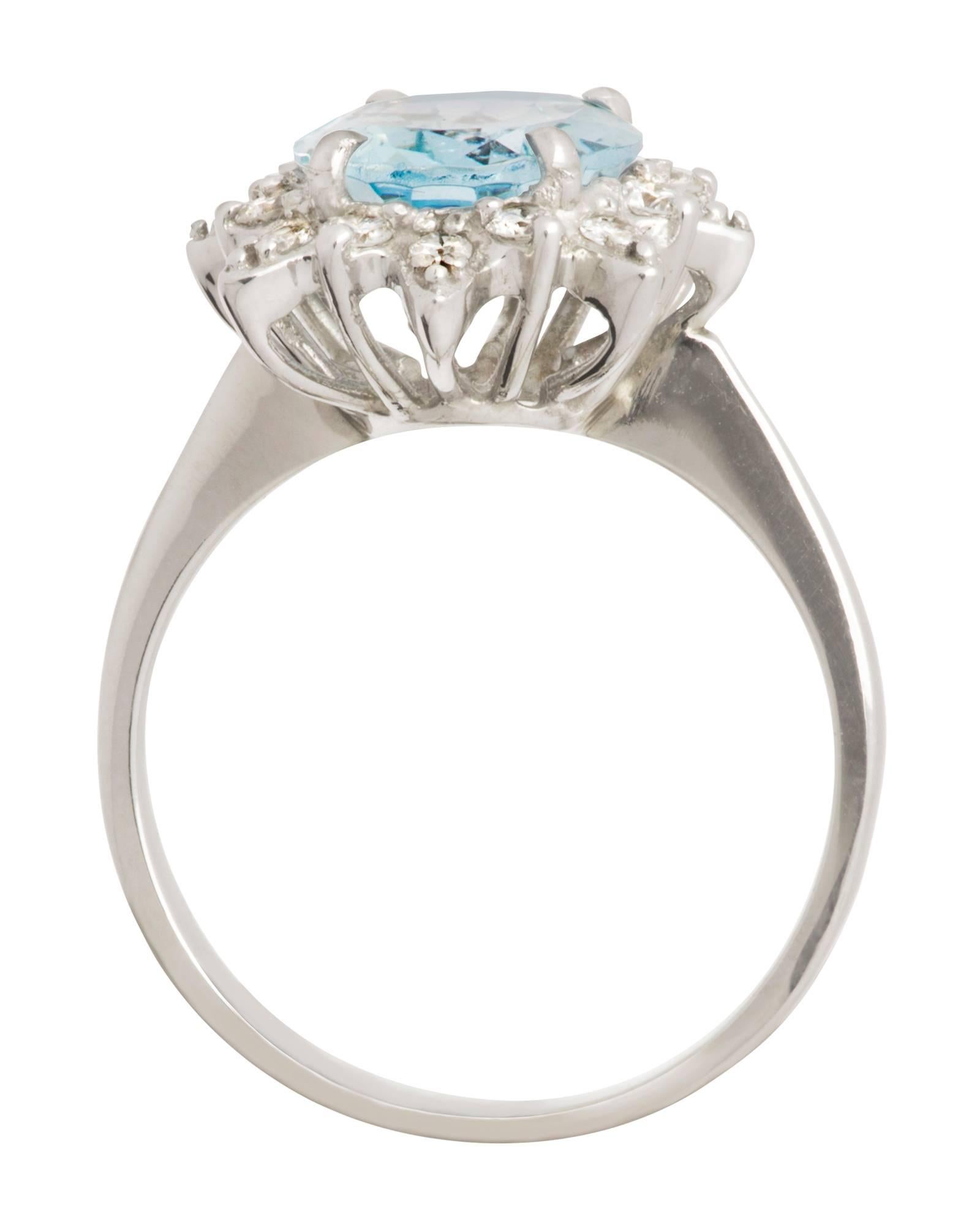 Beautiful aquamarine ring in 14k white gold.  Large oval cut approximately  5 ct aquamarine, surrounded by sixteen  .03 diamonds.  Total of .50 ct diamonds, Total weight 4.3g.  Overal stone size with diamonds. 16mm X 13mm
Ring size 7.25