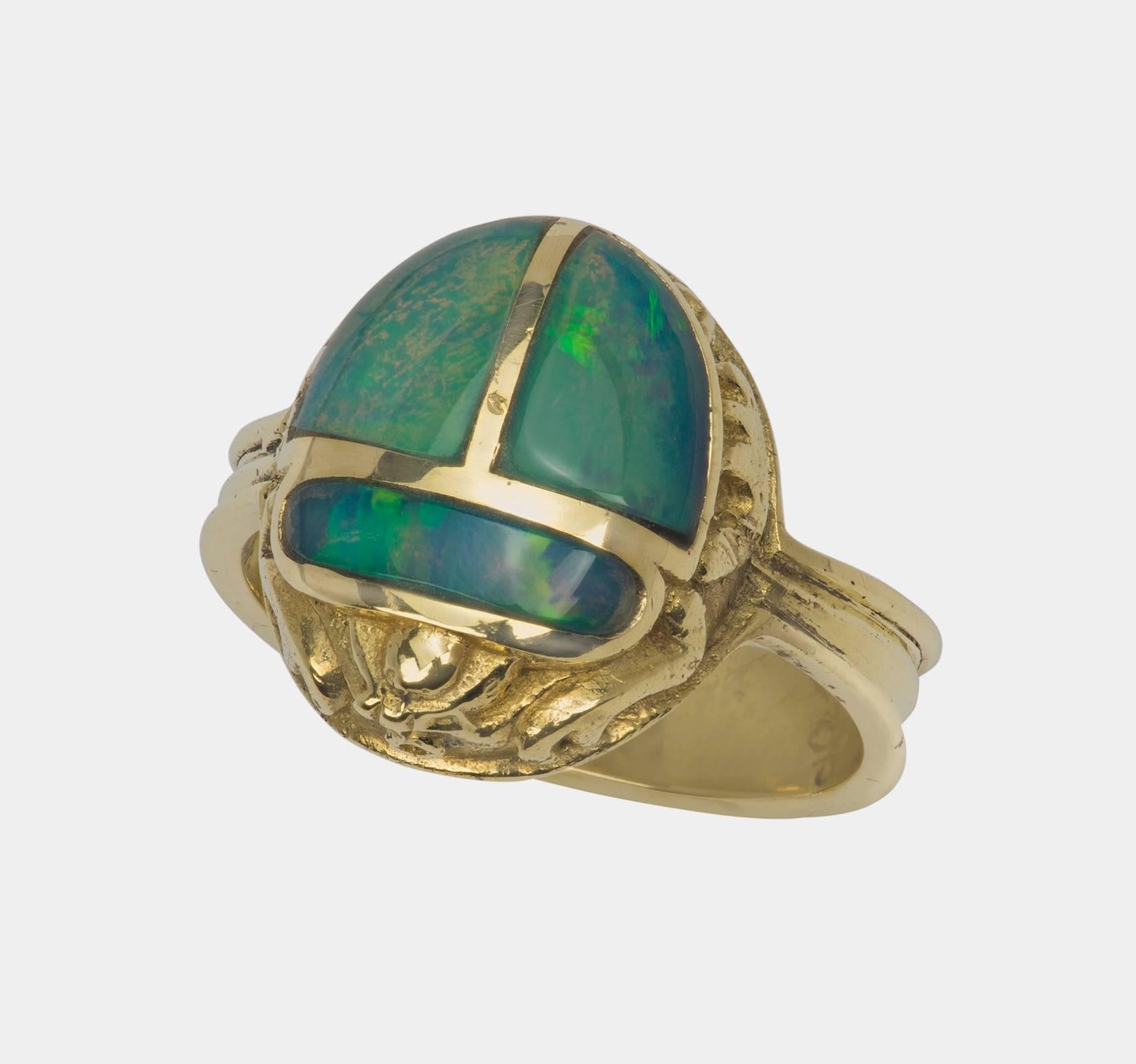 Superbly hand made opal scarab ring in 18k yellow gold.
Opal is strikingly beautiful luminescent green.
Size 7.25  8.7g
Scarab size:  12mm X 14mm
Marked d t 18k