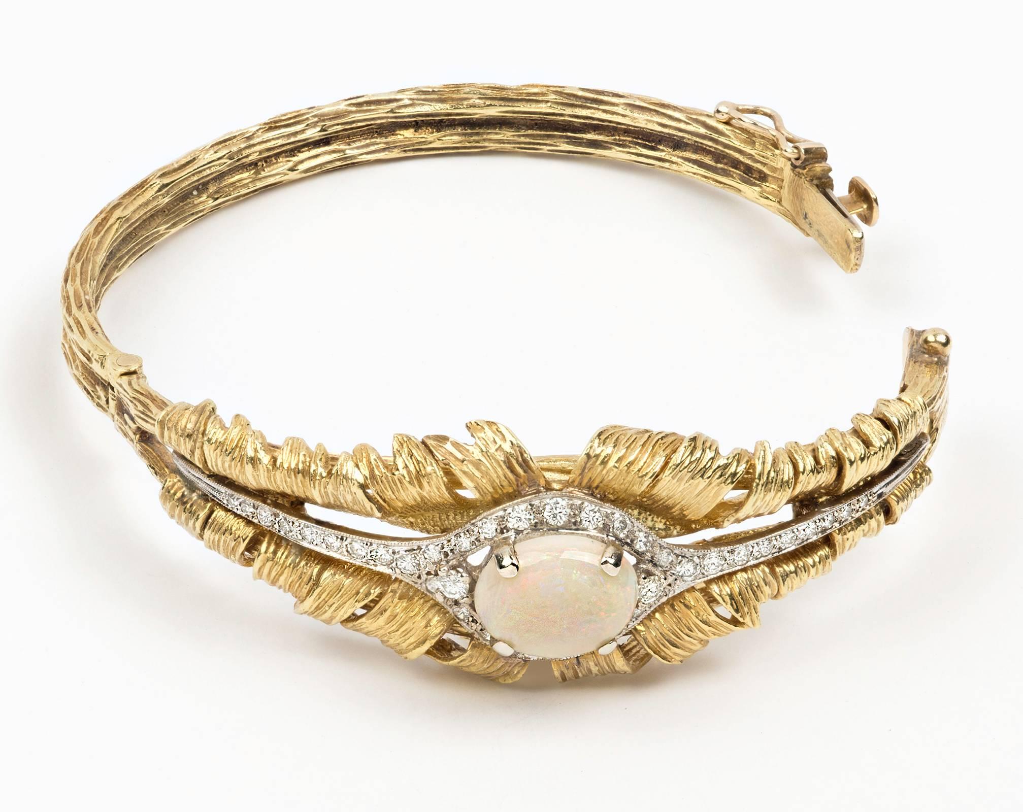 Beautifully made c. 1930s Opal and diamonds, 18k yellow gold bracelet.
Large cabochon Opal center surrounded by diamonds.
Total of approx. .68 ct. Diamonds
Oval Opal is 10mm X 8mm.
Interior size of the bracelet is 2. 1/16 wide X 1 3/16 deep