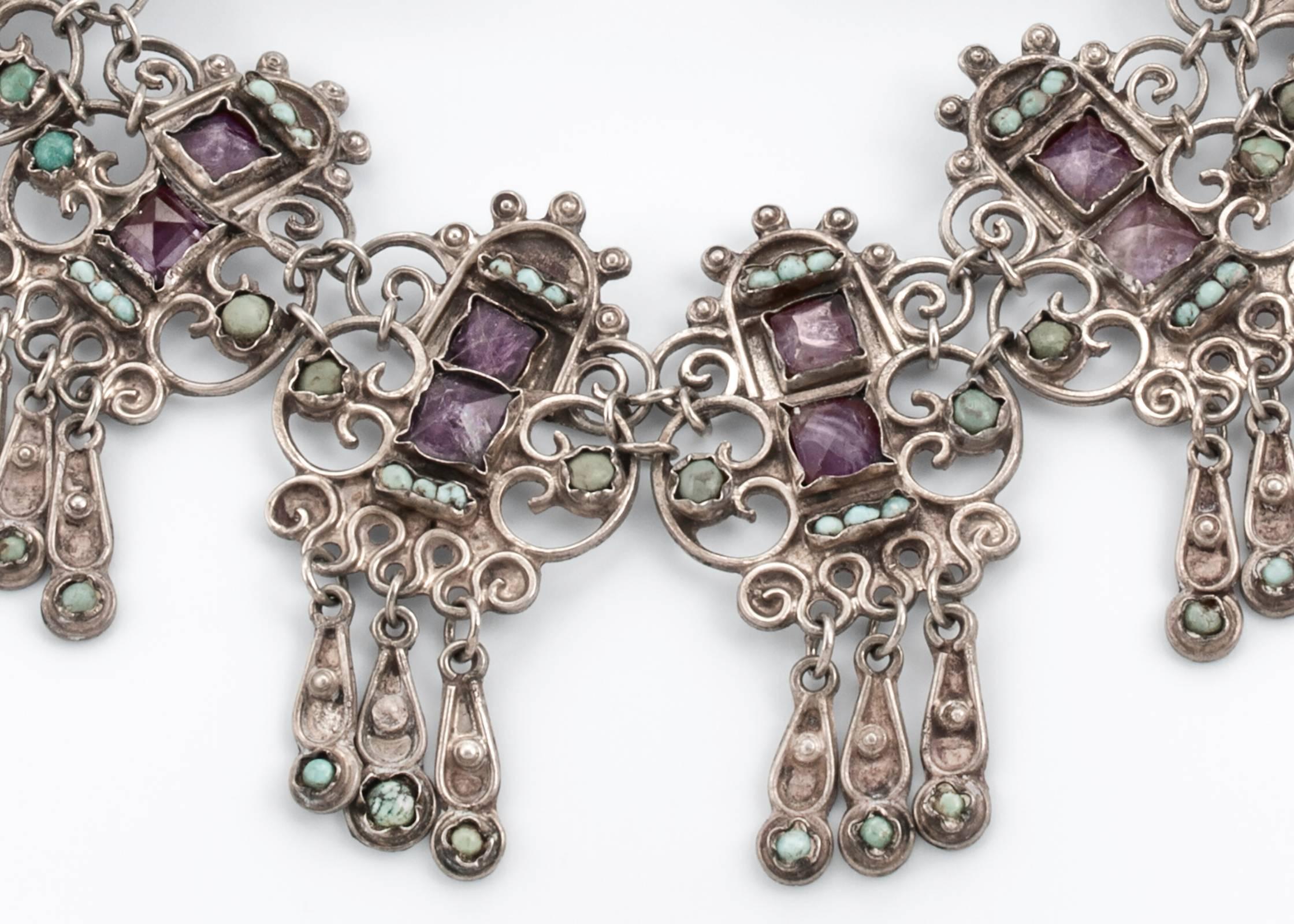 Dramatic bib style necklace.  Mexican Sterling silver embedded with amethyst and turquoise.  There are 17 links, about 1