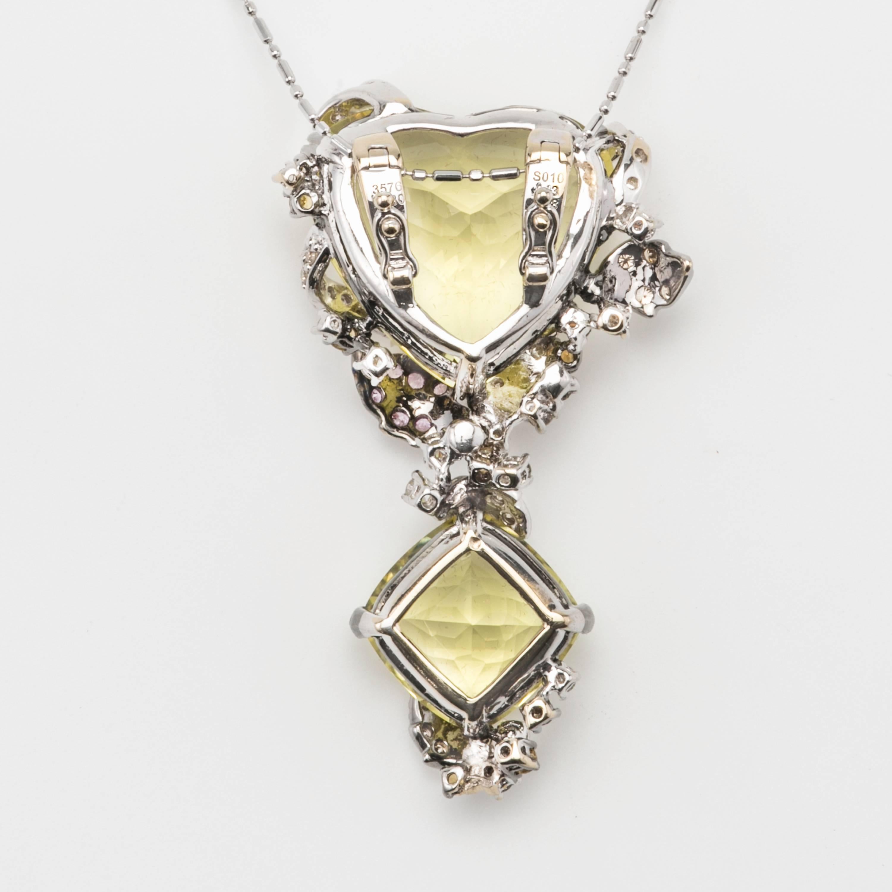 Dazzling huge two piece lime quarts on 18k white gold mount, surrounded by diamonds and pink sapphires.  Pendant hangs on a 14k sparkling white gold 24” chain.
Lime quartz 35.76 ct.
Pink sapphire 0.10
Diamond. 0.80
Total weight. 16.2 gm


