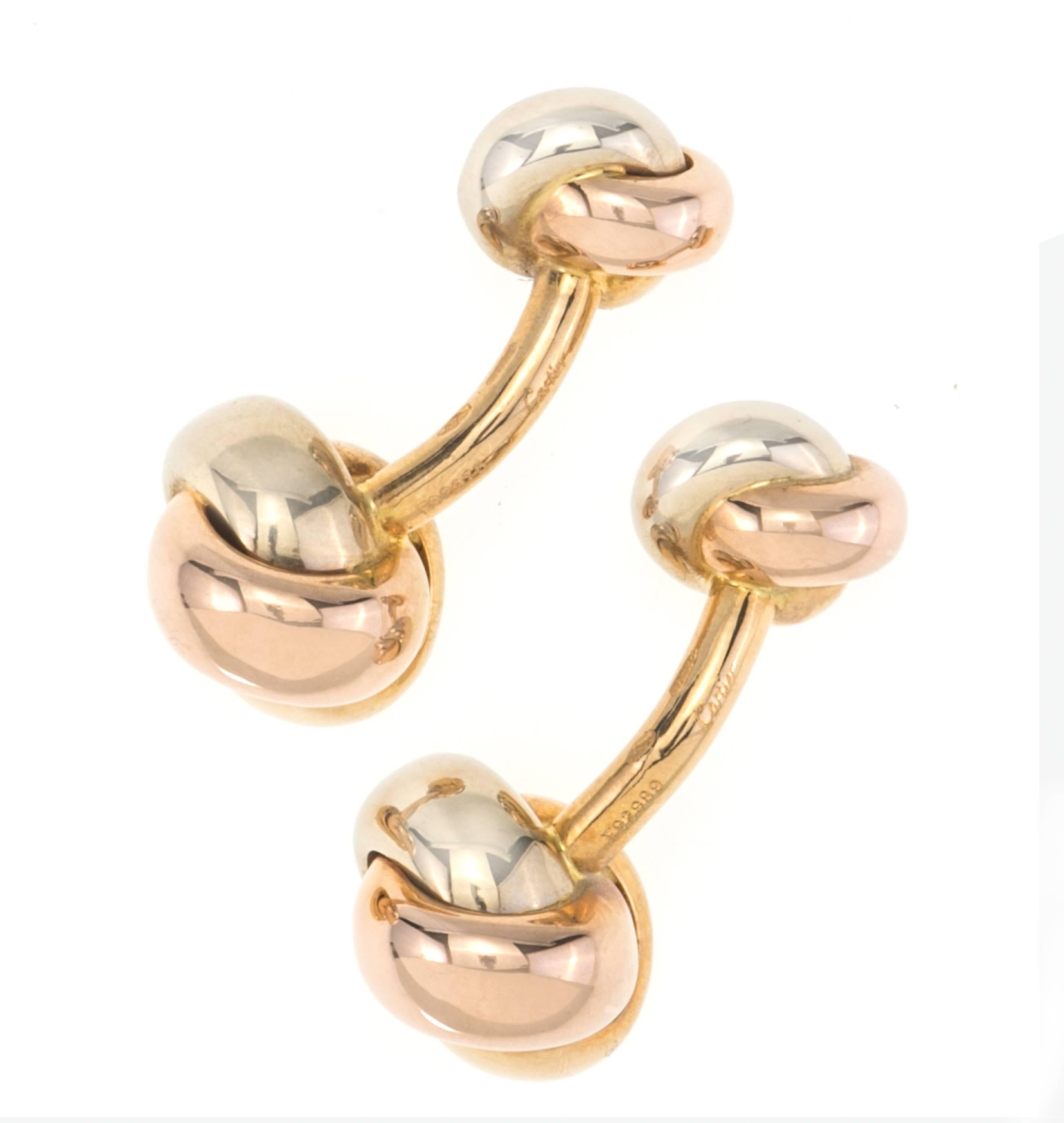 Cartier 18k tri l color knot cuff links.  Knots made up of 18k white, yellow and rose gold.  Original Cartier Box included.  Cartier hallmarked and Serial number on the shank.