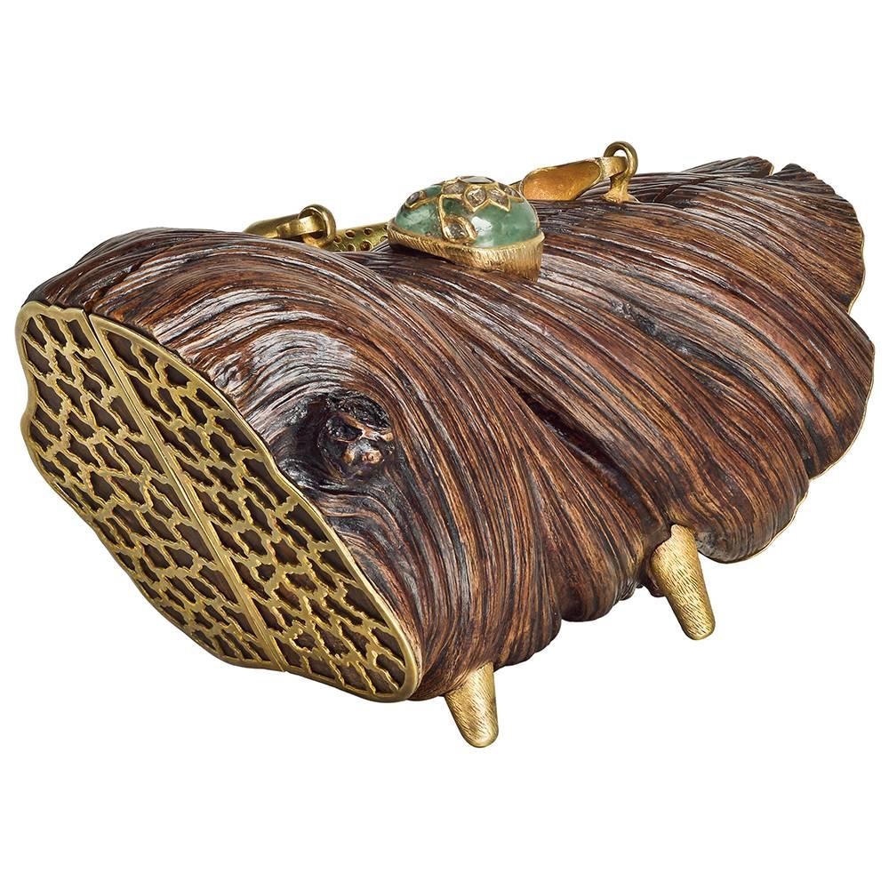 Nature-inspired handbag in elegantly carved Liana wood with yellow-gold plated ends, feet and handle. The handbag secured by a large emerald clasp with inset table-cut diamonds in a foliate pattern. Designed by Lotus Arts de Vivre. 10
