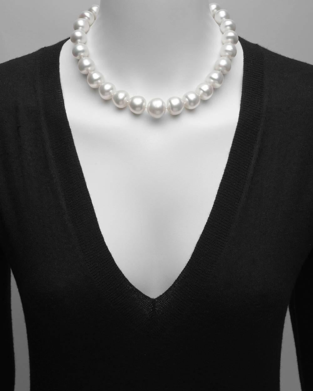 Graduated semi-baroque pearl necklace, composed of 28 cultured pearls measuring approximately 18mm to 13mm in diameter, strung on a hand-knotted silk cord and secured by an 15.5mm engraved 18k white gold clasp, set with forty small full-cut round