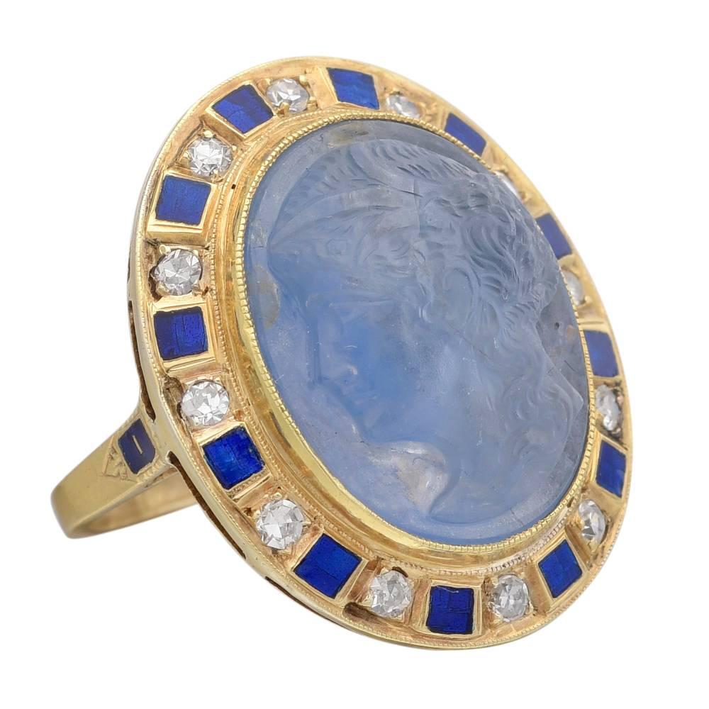 Dress ring, showcasing an elegant carved oval-shaped sapphire cameo of the bust of an aristocratic woman, with circular-cut diamonds and blue enamel accents, the diamonds weighing approximately 0.12 total carats, mounted in 18k yellow gold, the ring