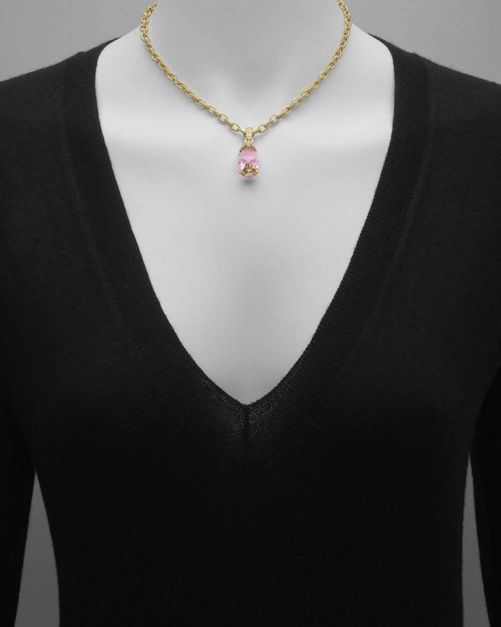 Pendant necklace, centering a faceted pink quartz drop, on a 16