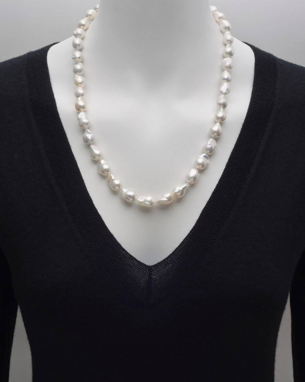 Cultured baroque pearl necklace, composed of 39 pearls measuring approximately 10 to 14mm in diameter, secured by a navette-shaped, fisherman-style hook14k yellow gold clasp. 23