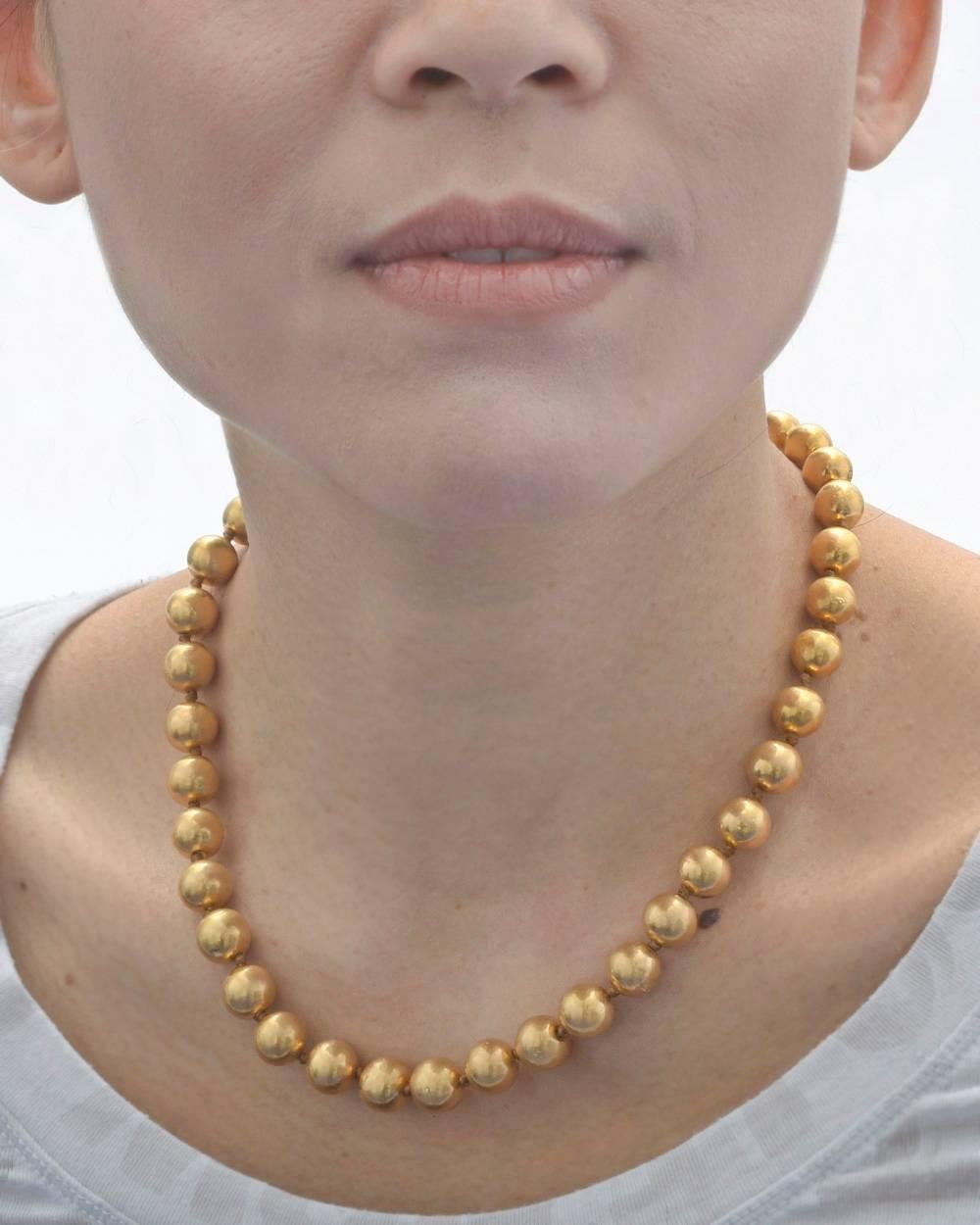 Lightweight 22k yellow gold bead necklace, each 9-10mm bead strung on silk and knotted in place. 17