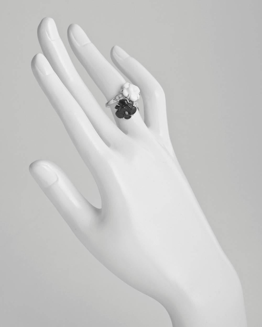 Twin camélia ring, centering two camélia flowers of carved black onyx and carved white agate with diamond set leaves, in 18k white gold, signed Chanel. Ring size 4.75.

Current retail is $3,650