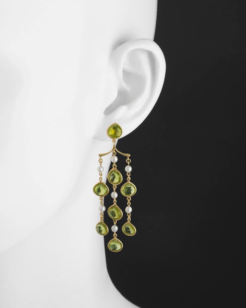 Peridot and pearl chandelier earrings, each composed of three bezel-set peridot and pearl chain link drops suspended from a peridot top, in 18k yellow gold. 2.6