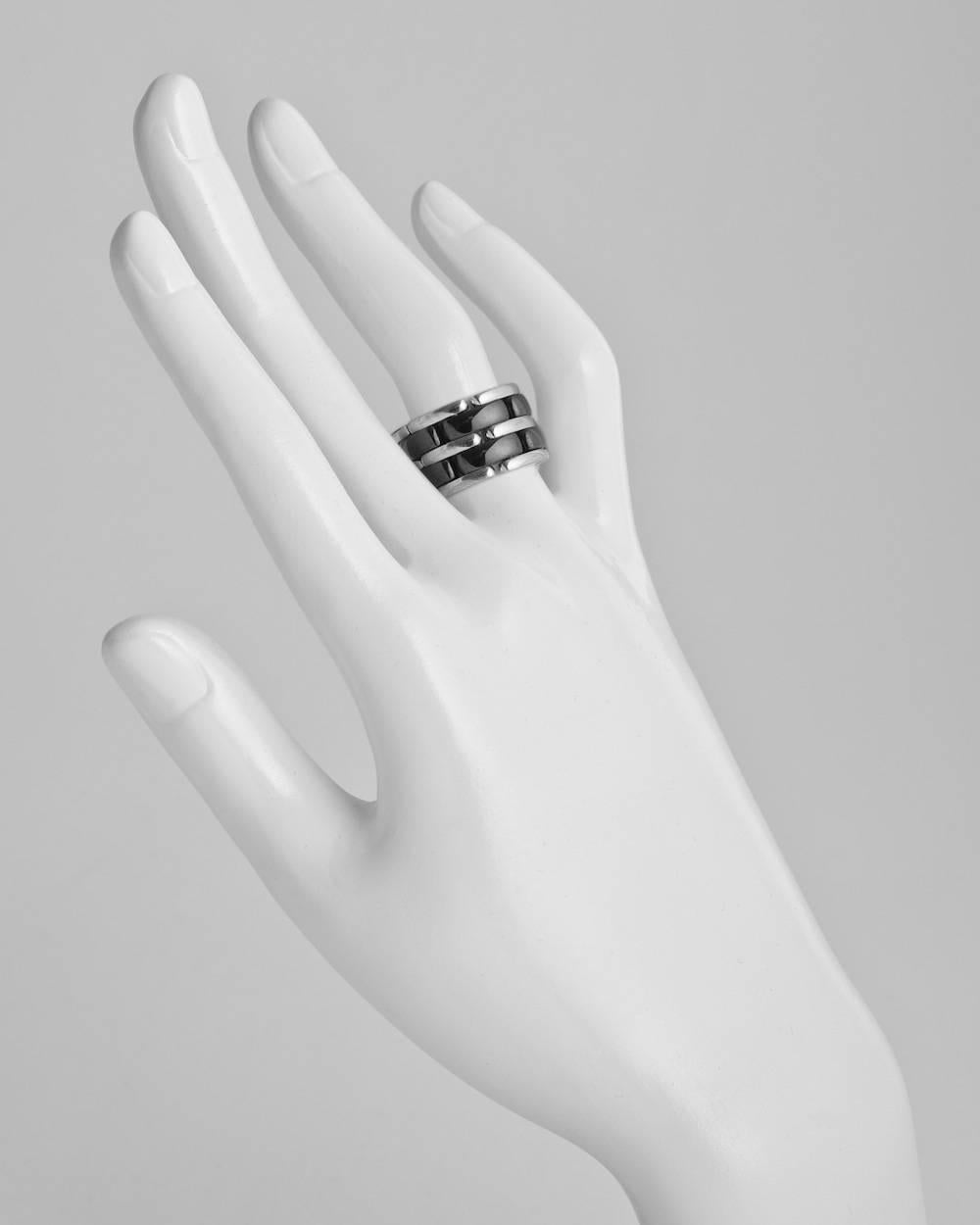 Large 'Ultra' band ring, composed of two rows of black ceramic links alternating with 18k white gold links, signed Chanel. Ring size 9. 12mm width.

$3,350 current approximate retail