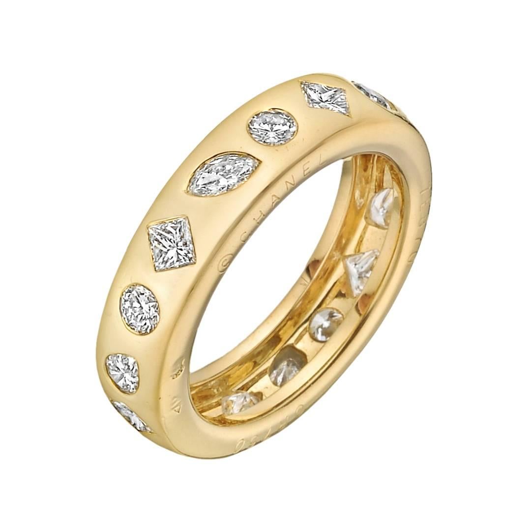Chanel diamond band ring, set with princess, marquise, round, pear and triangle shaped diamonds, in 18k yellow gold, signed Chanel, numbered 7E870.  Five princess cut diamonds weighing approximately 0.50 total carats, three marquise cut diamonds