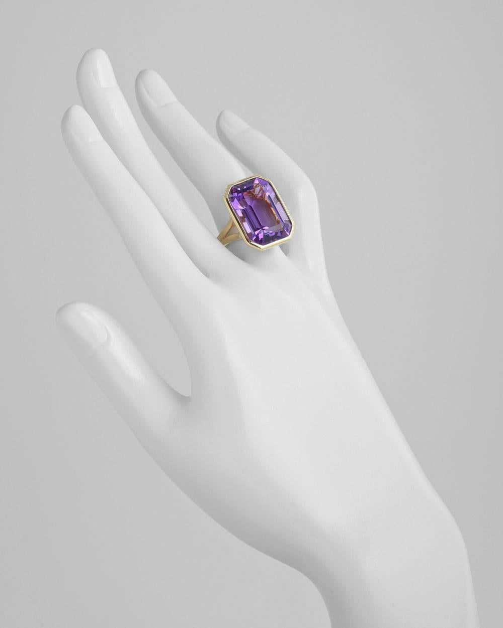 Emerald-cut amethyst cocktail ring, mounted in polished 18k yellow gold with an elegant split shank. Amethyst measuring 20 x 14mm. 11.36 grams weight. Designed by Goshwara. Size 4.5
