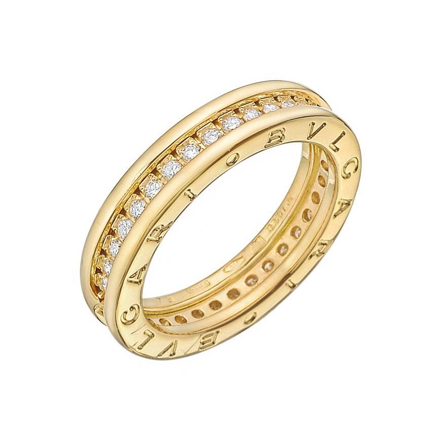 B.Zero1 diamond and yellow gold band ring, composed of a single row of bead-set diamonds weighing approximately 1.00 total carats, in 18k yellow gold, signed Bulgari. 5mm width. 6.58 grams weight. Ring size 7. 