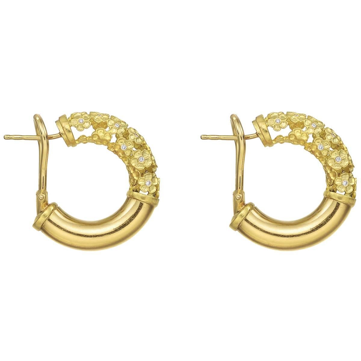 "Flower Tube" hoop earrings, designed as a tube of openwork flowers with diamond centers, in 18k yellow gold, signed Paul Morelli. 30 diamond accents weighing approximately 0.10 total carats. Post and Omega-clip backs.
0.94" (24mm)