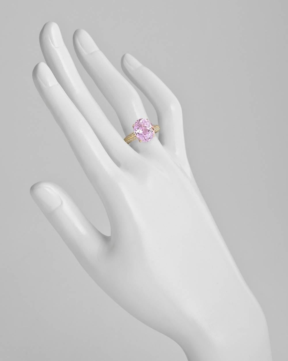 Kunzite and diamond ring, featuring an oval kunzite weighing approximately 6.46 carats, with diamond-accented shoulders, in 18k yellow gold. Diamonds weighing approximately 0.38 total carats. Size 5.5.