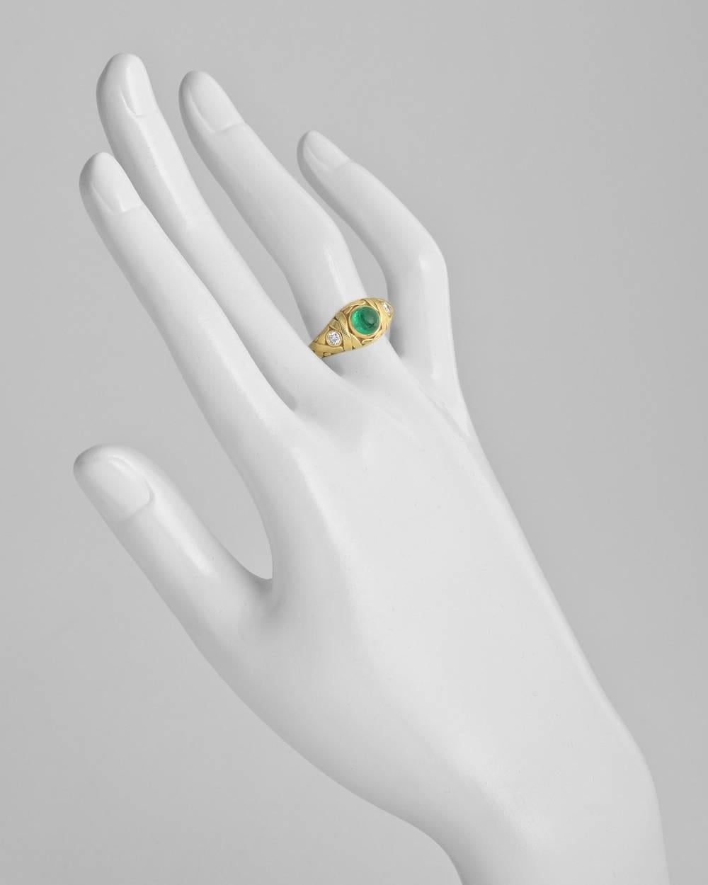 Dress ring, centering a circular cabochon-cut emerald measuring approximately 6mm in diameter in a hand-engraved 18k yellow gold 'X' weave-patterned mounting with a single round-cut diamond accent at either shoulder, signed Alex Sepkus. Size 6.25.
