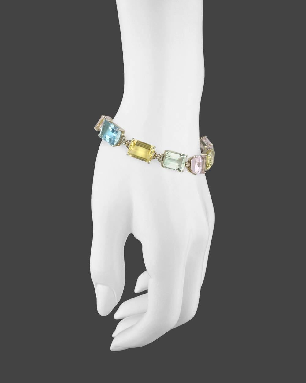 Multicolored beryl link bracelet, showcasing emerald-cut green, pink, yellow, white, and blue beryl, in 14k white gold. Just over 7.5
