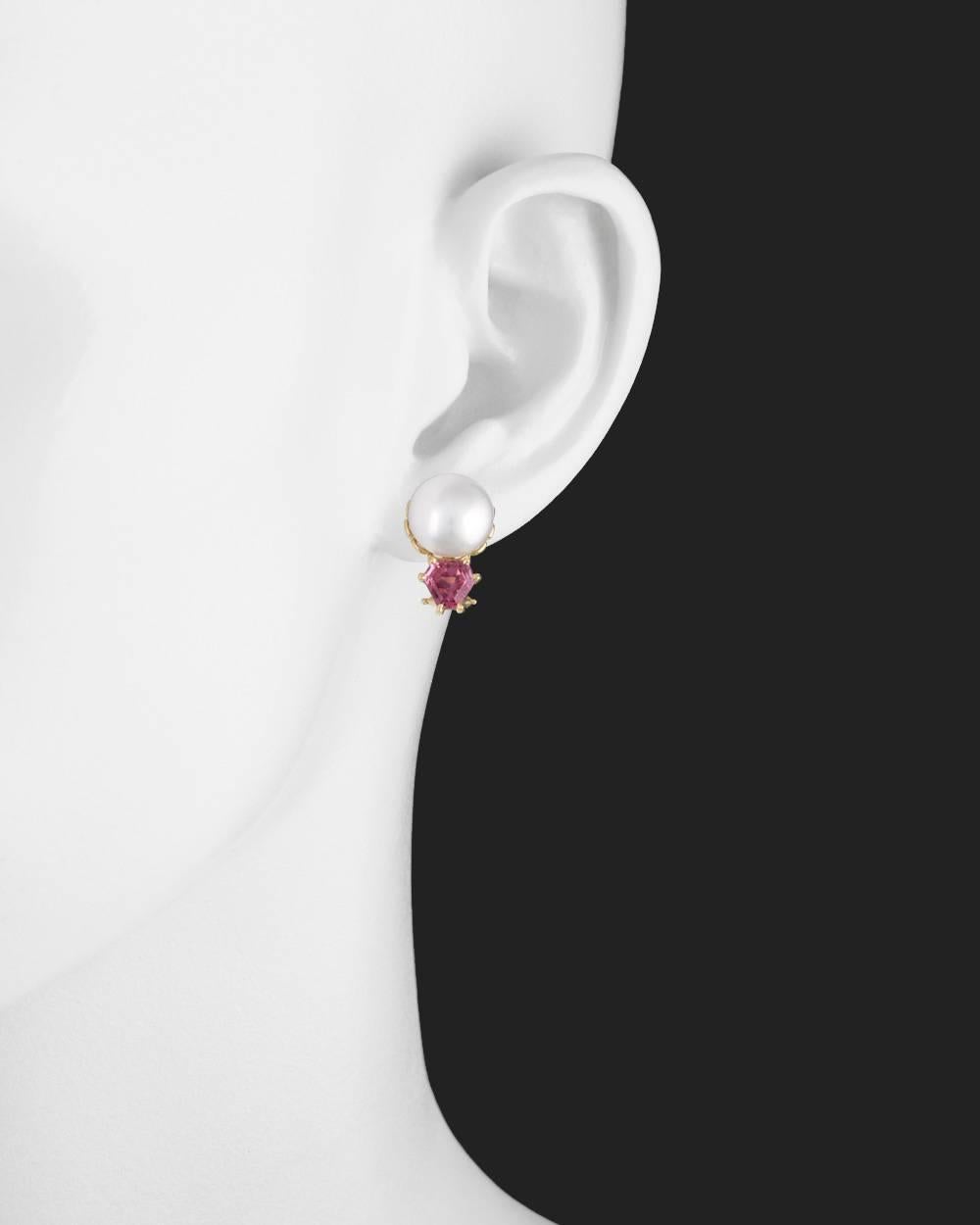 Pearl and pink tourmaline stud earrings, each featuring a freshwater button pearl and a hexagonal pink tourmaline accent, in 18k yellow gold. Pearls measuring 10.6mm in diameter. Pink tourmalines weighing approximately 2.05 total carats. 