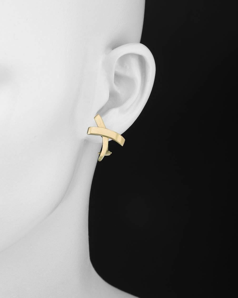 Paloma Picasso 'X' earclips, in polished 18k yellow gold, signed Tiffany & Co. Omega-style clip backs with posts. 1" length and 0.7" width at widest point.