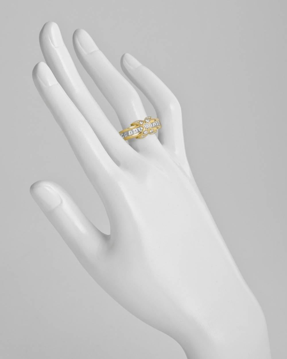 Band ring, centering a round-cut diamond-set 'X' motif, flanked by a row of channel-set square-cut diamonds, in 18k yellow gold, signed Tiffany & Co. Accompanied by Tiffany ring box. Size 5.75.
