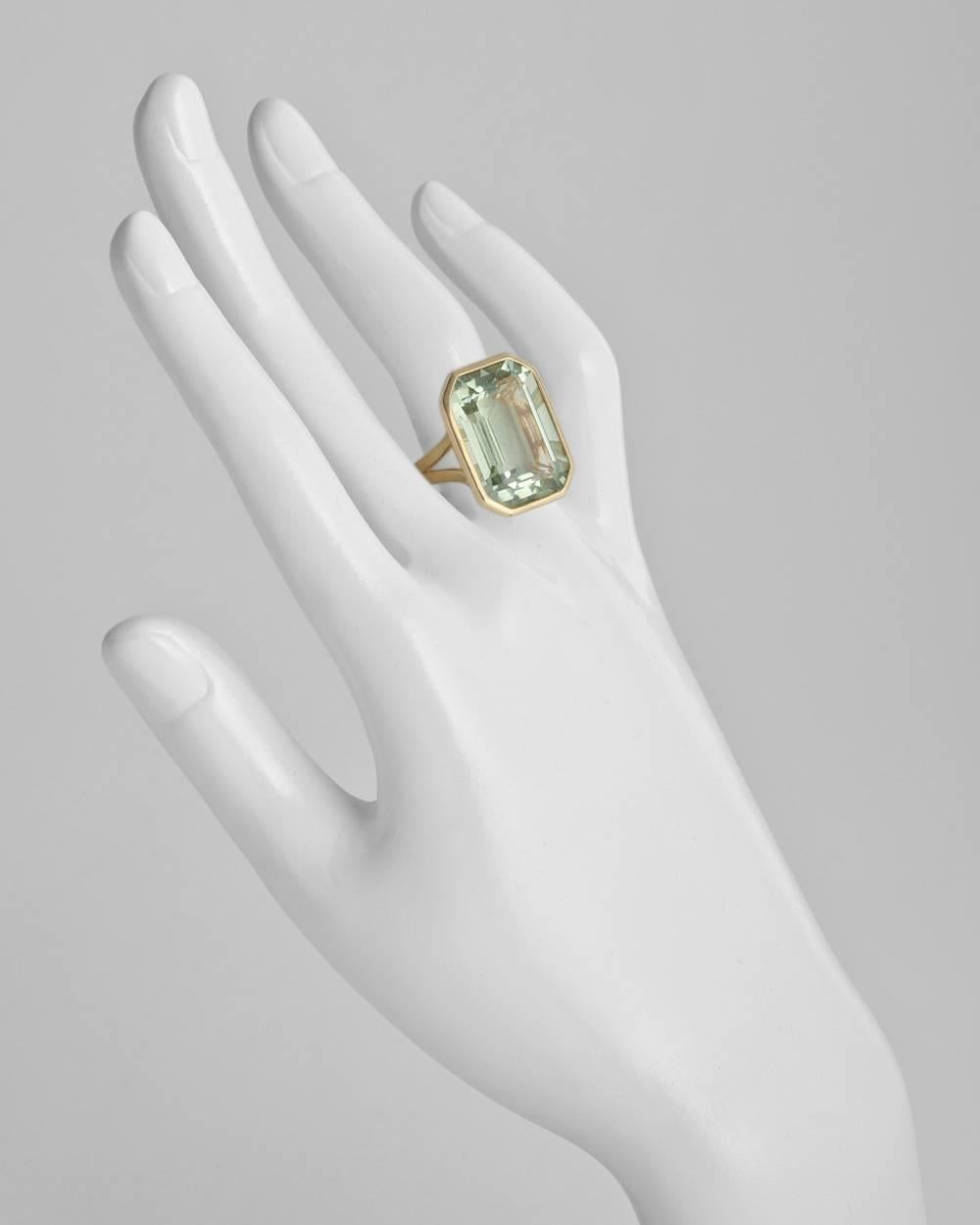 Bezel-set prasiolite cocktail ring, showcasing an emerald-cut prasiolite weighing 17.99 carats and measuring 20 x 15mm, mounted in 18k yellow gold with a split shank, designed by Goshwara. Size 7 (resizable to most ring sizes).