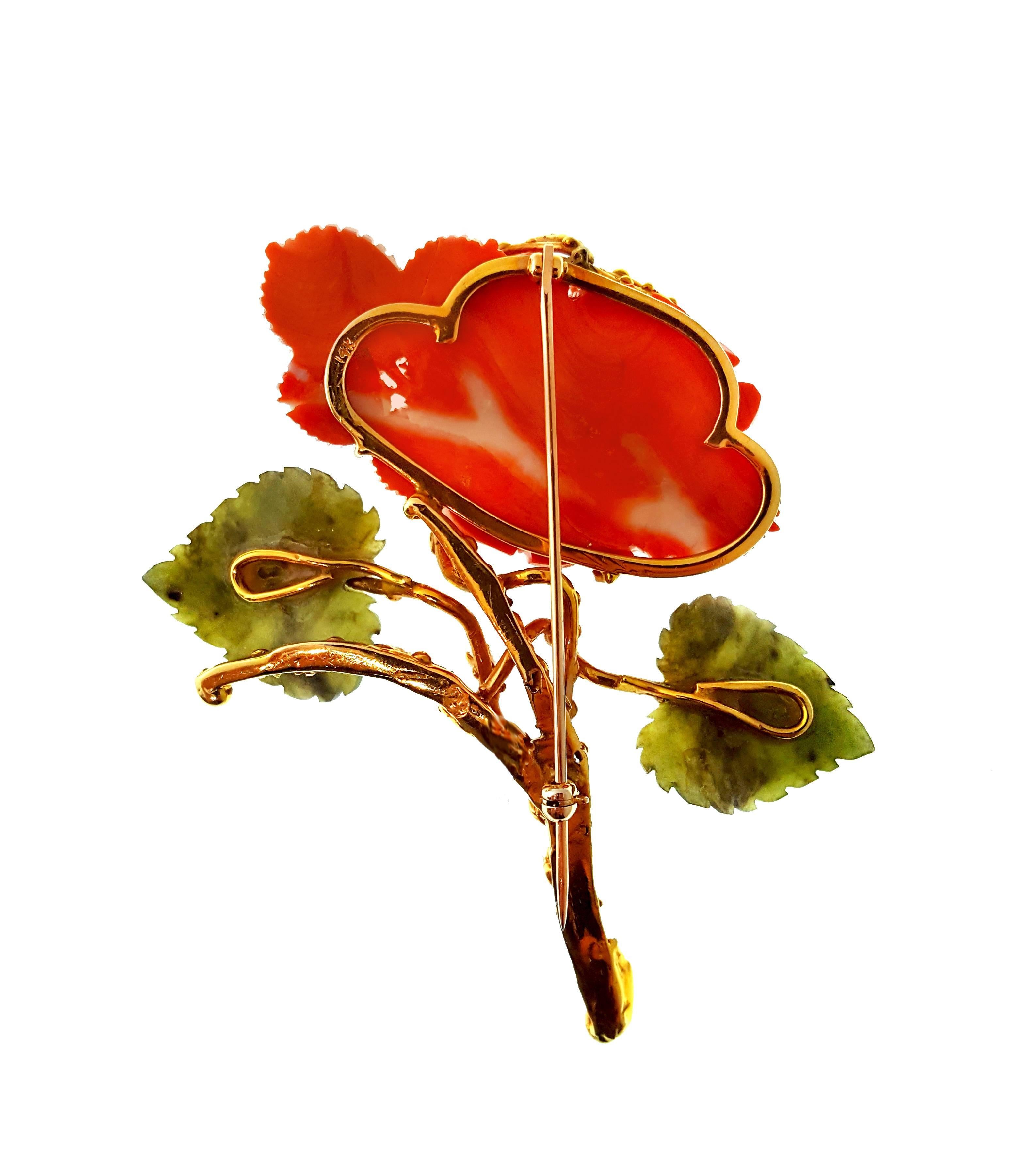 Feminine, vintage, carved coral and nephrite jade brooch in textured and polished 14kt yellow gold with .56ctw of diamond accents. Features a straight pin with 