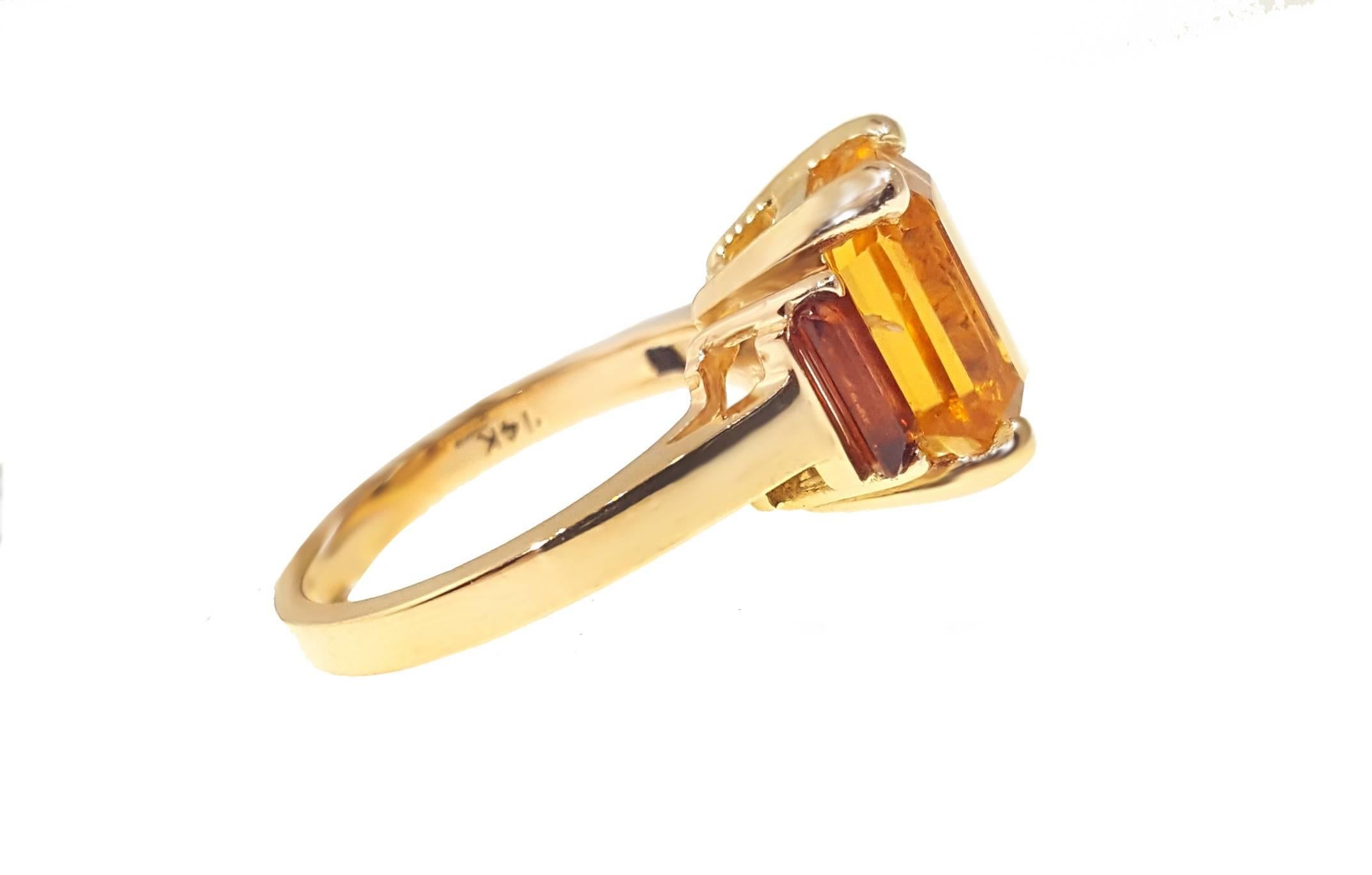 Fun retro style high polish 14kt yellow gold ring with a 3.57ct medium orangy-yellow natural citrine, accented by two dark red garnets.  The ring measures approximately 13.2mm x 10mm at the top and is a US size 6.5. 