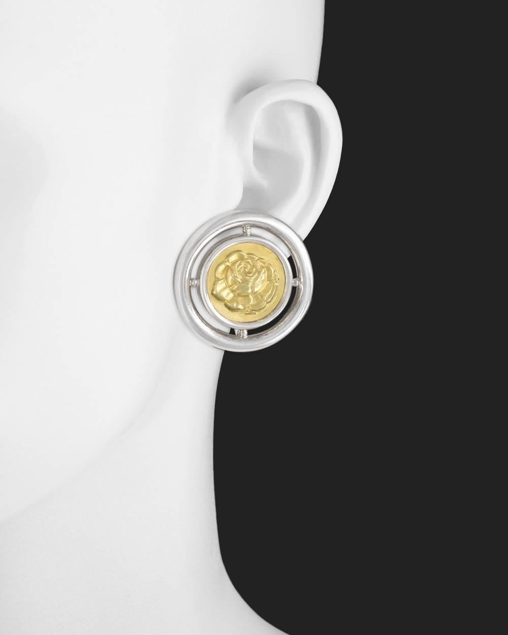 Round earclips, in sterling silver with 18k yellow gold rose motif centers, made in Greece, with stamps for Ilias Lalaounis. 1.3" diameter. 26.9 grams total weight.