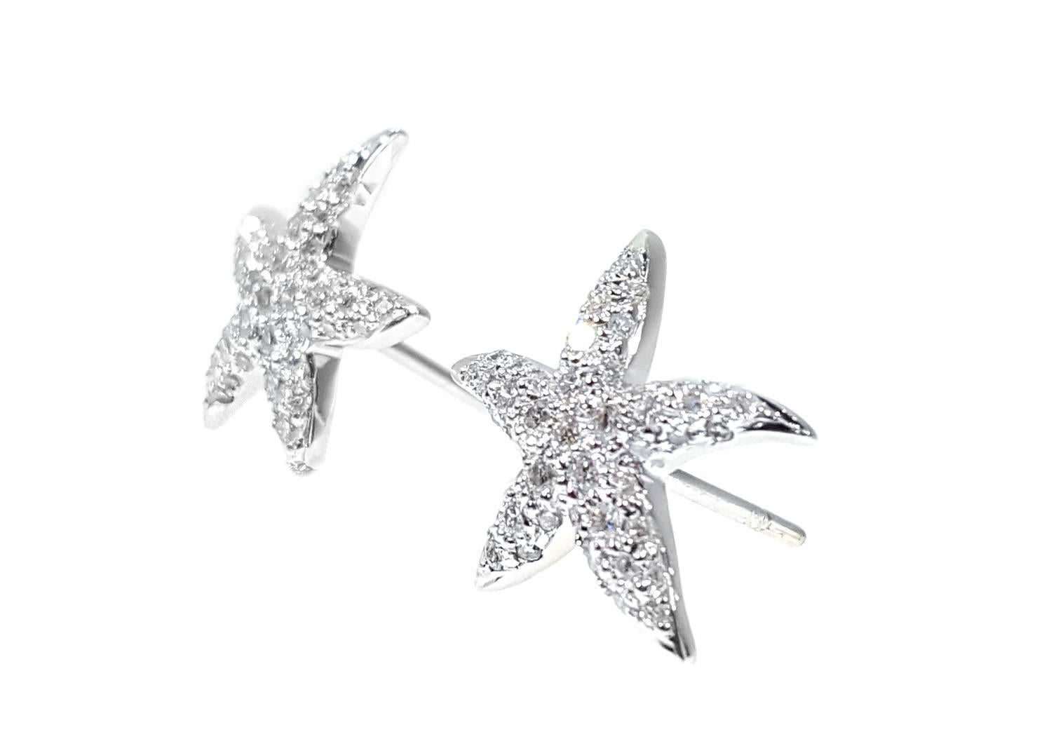 Sparkling starfish earrings with .51ctw of full cut round brilliant diamonds pave set in high polished 18kt white gold. Earrings measure approximately 5/8