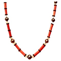 Very chic reddish orange natural coral, Tahitian pearl, crystal and black onyx