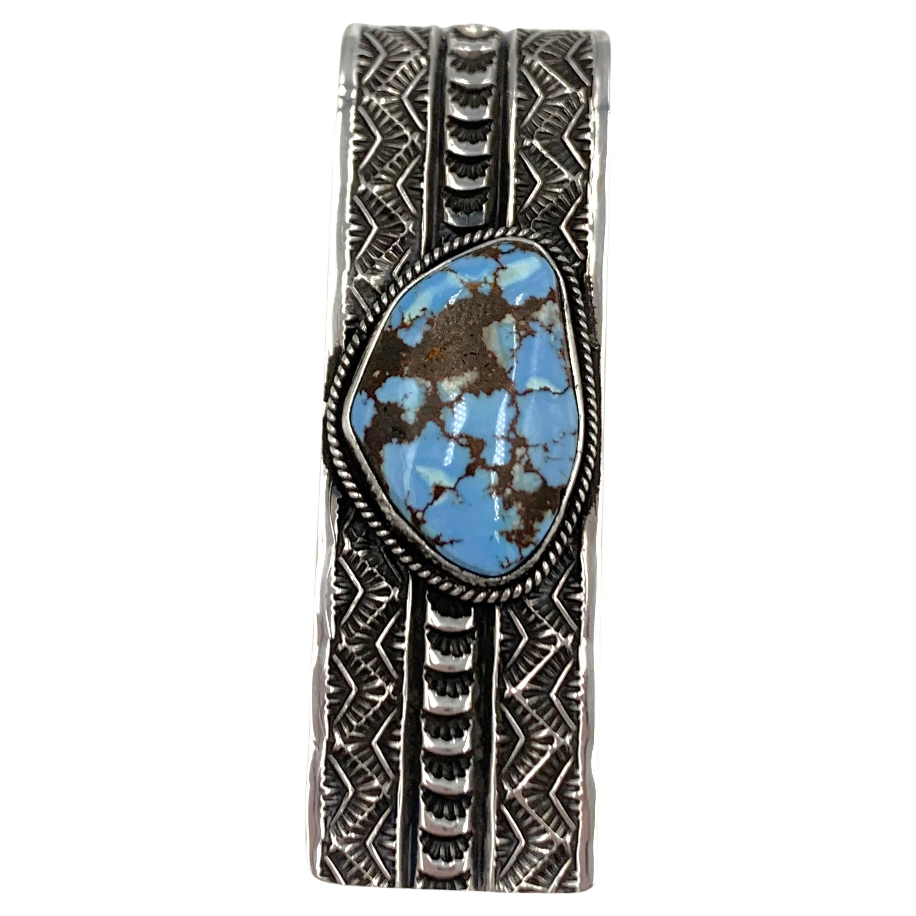 Golden Hills Turquoise Money Clip by Navajo Silversmith Sunshine Reeves

Daniel “Sunshine” Reeves was born in 1966 into a family of silversmiths.  His older brothers, Gary and David (both deceased) taught him the art of working in silver, with which