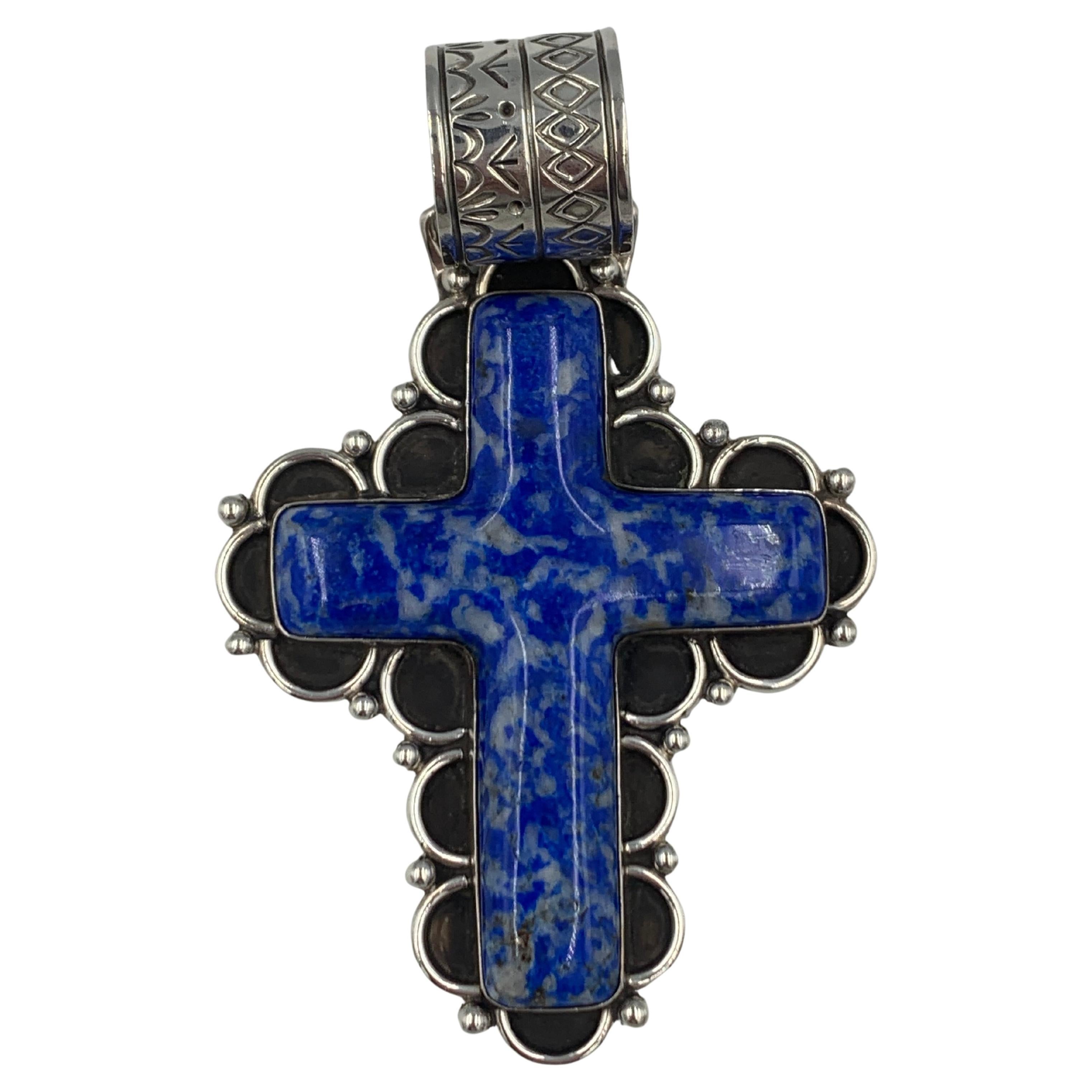 Sterling silver and lapis cross by Navajo silversmith Philbert Secatero. The cross is beautifully handmade using traditional Navajo techniques. 

Cross Measures: 2 1/4” x 3” with a 3/4” bale
Total Length:  3 3/4”

Philbert Secatero's hallmarked by