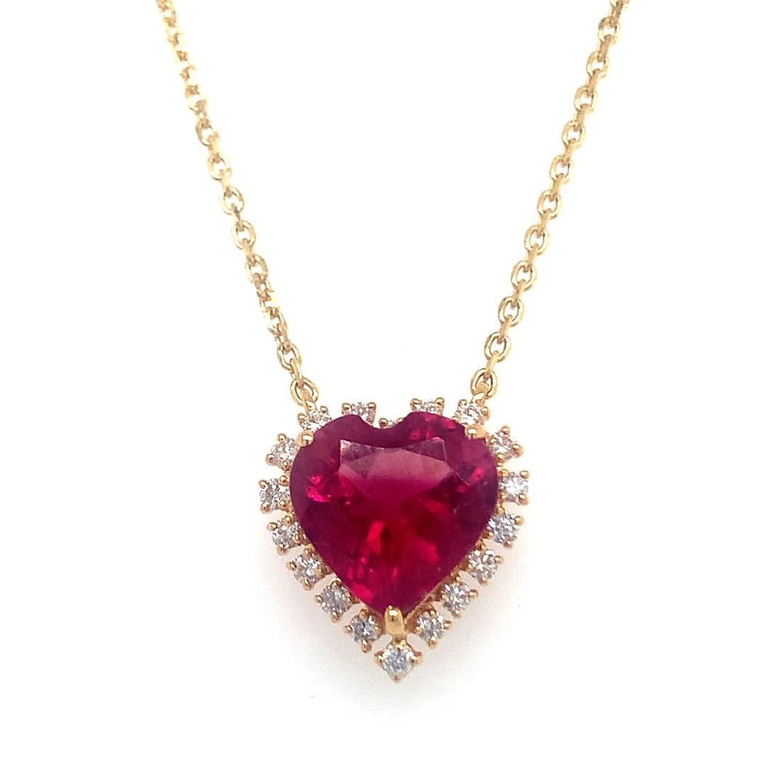 An stunning necklace set in 18 karat yellow gold, containing a natural 4.18 carat heart shape rebelite and 0.34 carat vs quality diamond.