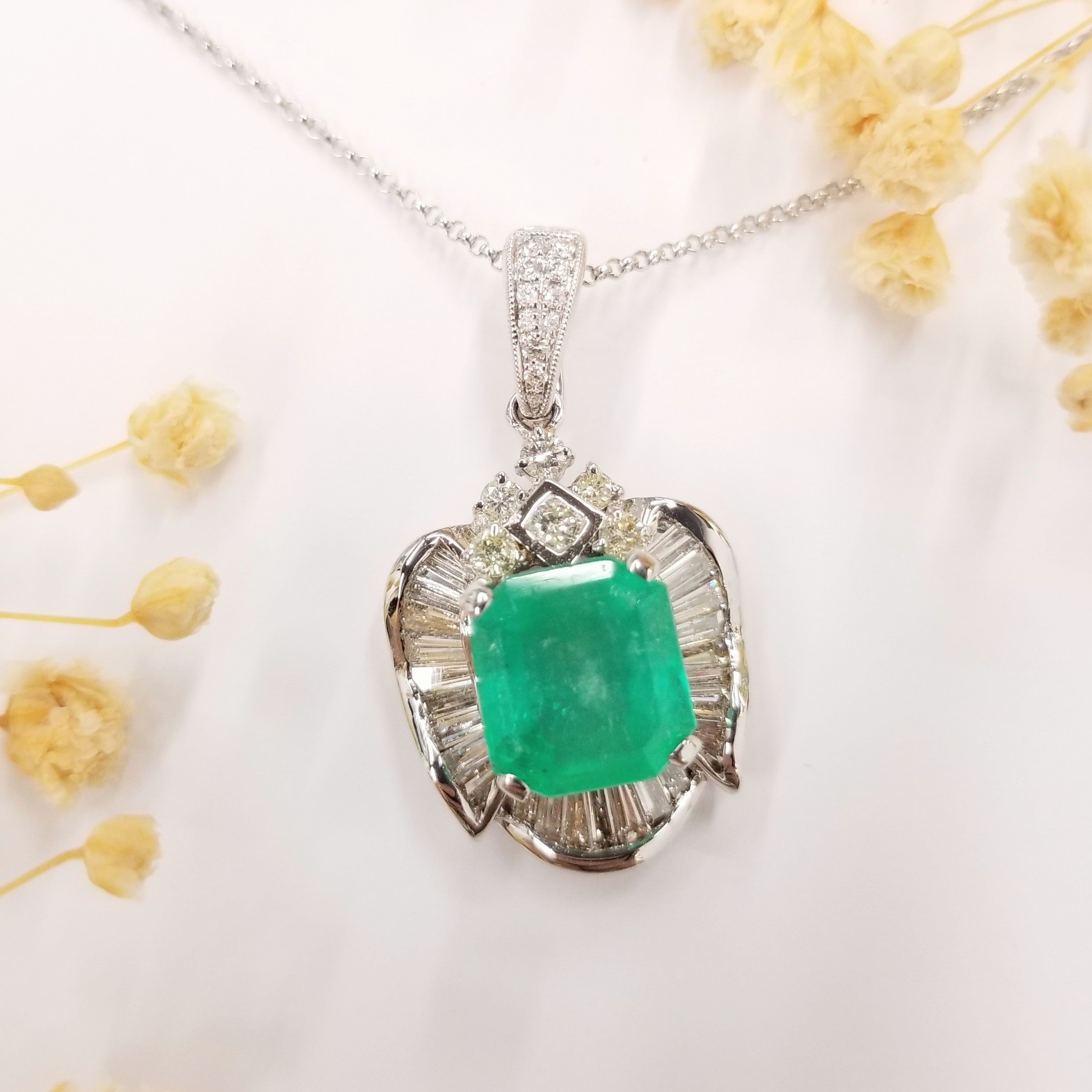 This exquisite pendant features a stunning IGI certified 3.97 carat Colombian Emerald in an elegant emerald shape. The emerald showcases a beautiful vibrant green color, known for its exceptional quality. This gemstone is sourced from the renowned