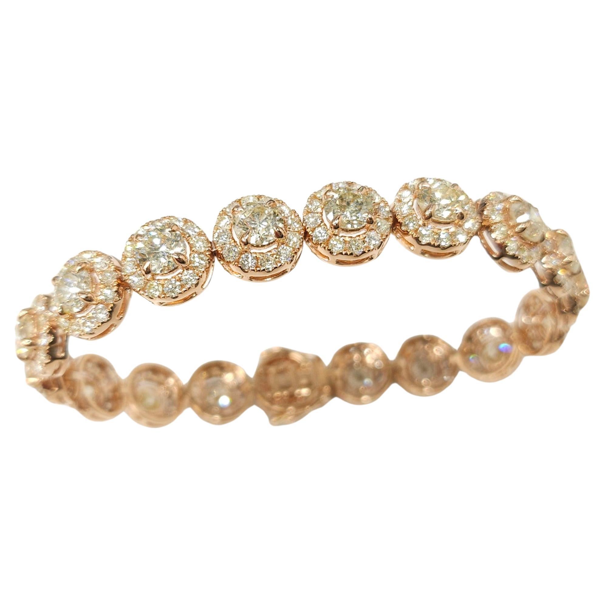 Prepare to fall in love with the sheer radiance and elegance of this exquisite 12.25 Carat Total Round Diamond Tennis Bracelet. Crafted in luxurious 18K rose gold, this bracelet showcases a stunning single row halo design that is sure to captivate