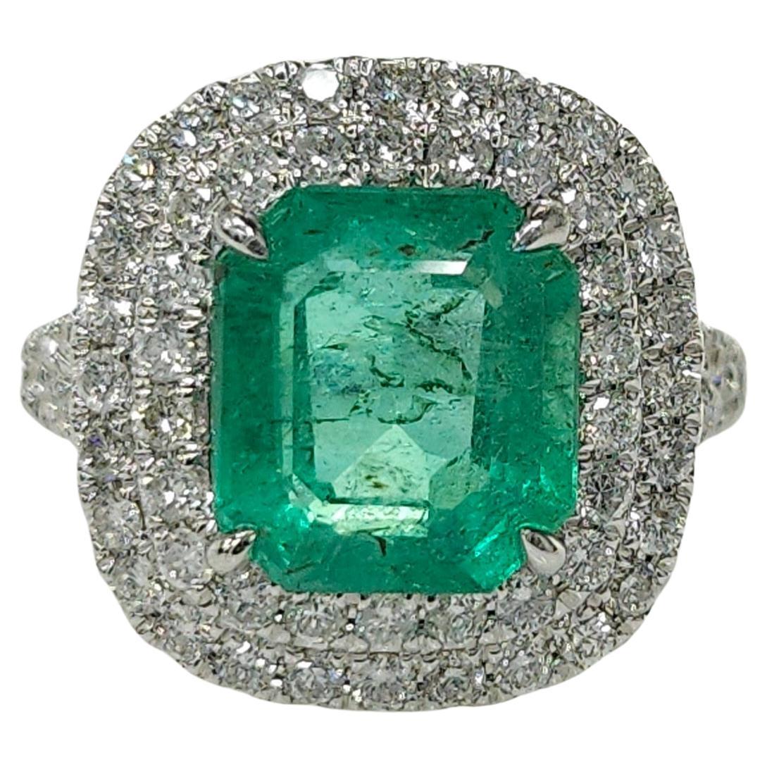 Introducing the extraordinary IGI certified 18K white gold 3.39 Carat Colombian Emerald & 0.95ct diamond ring, a truly mesmerizing piece of jewelry that celebrates the captivating beauty of an emerald-shaped gemstone. This exquisite ring is a