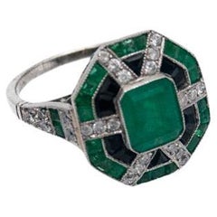 Anillo Art Decó de platino con esmeraldas, ónices y diamantes, años 40.
