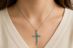 18k white gold cross pendant with emeralds and diamonds