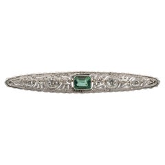 Oblong old platinum and yellow gold brooch with diamonds and tourmaline.