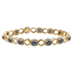 Elegant 18k gold bracelet with sapphires and diamonds.