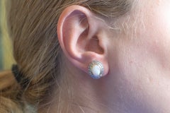 Elegant vintage stud earrings with opals and diamonds.