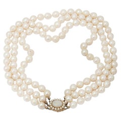 Three-row antique pearl necklace with a gold clasp adorned with opal
