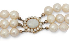 Three-row antique pearl necklace with a gold clasp adorned with opal