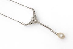 Antique platinum necklace with diamonds and pearl.