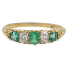 Antique 18-karat gold ring with emeralds and diamonds, early 20th century.