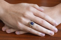 Antique ring with a cabochon-cut sapphire and old-cut diamond halo.